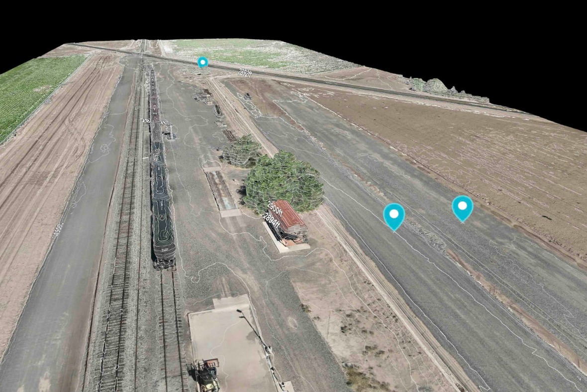 3D photogrammetric model of a railroad spur with RTK measurement pins and distance labels, processed by Lurid X